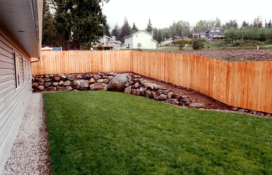 an after photo of a lush lawn and new fence